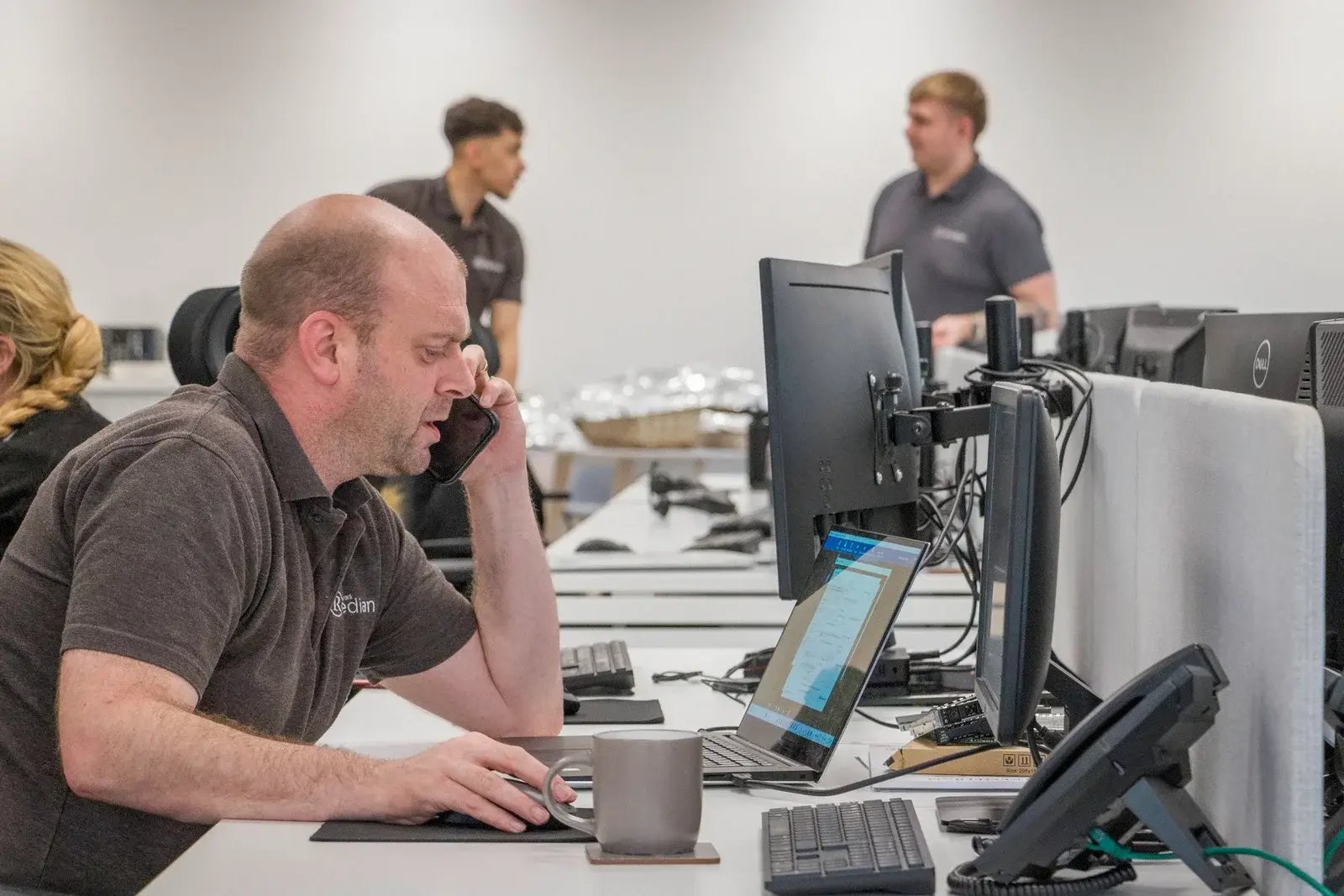 Remedian Cyber Analysts Monitoring Network Security Systems in Office