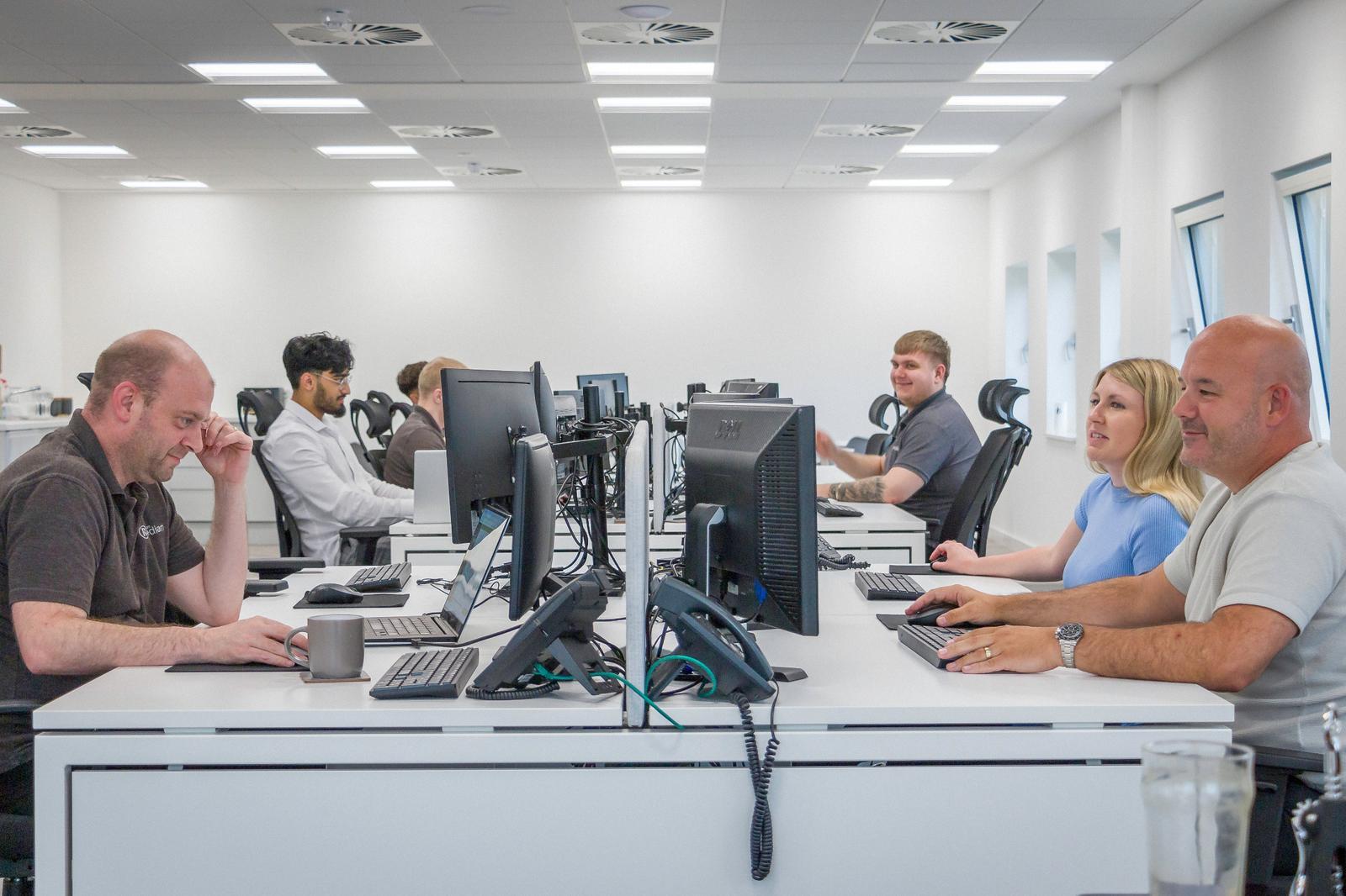 Remedian helpdesk staff providing IT assistance to clients in Oldham from local support office